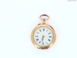 a gold pocket watch with roman numerals on the face
