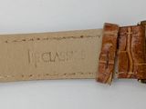 a watch that is sitting on top of a brown strap