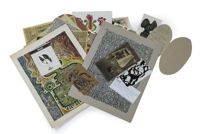 a pile of assorted cards and other items on a white surface
