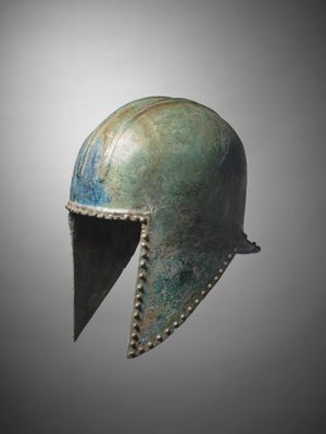 a bronze helmet on a gray background