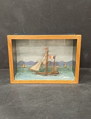 peinture représentant un voilier, dans un cadre en bois sur fond noir