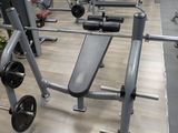 an image of a gym room with a bench and weights