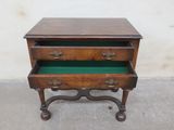 an image of a small wooden table with a green drawer underneath it