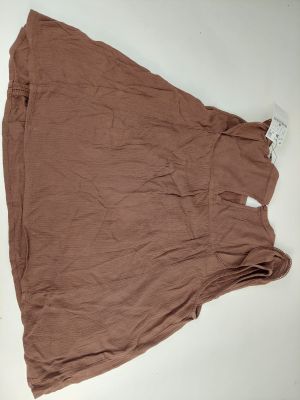 the skirt is laying on the table next to a pair of scissors