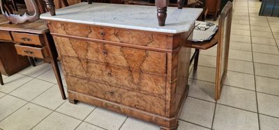 a wooden table with a marble top in the middle of a room
