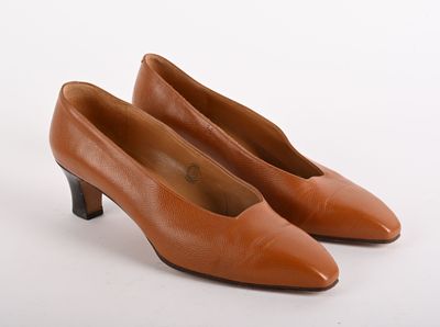 an image of a pair of brown shoes on a white surface