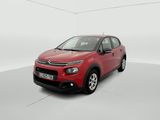 a red citrole is parked in a white room