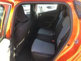 an orange car with black seats in the back of it