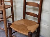 three wooden chairs sitting next to each other in a room