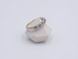 a close up of a diamond ring on a white surface