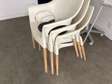 four chairs in the corner of a room with a white board