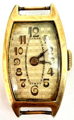 a close up of a watch on a white surface