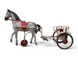 un cheval en jouet tirant une calèche dans laquelle se trouve un homme