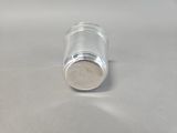 a silver pepper shaker sitting on a white surface