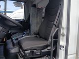 a white truck with a black seat in the back of it