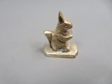 a small statue of a cat sitting on top of a table