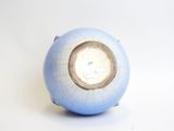 a blue and white vase with a hole in it