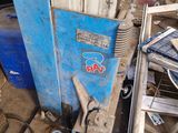 a blue machine that is sitting in the dirt