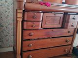 a dresser with a bunch of boxes on top of it