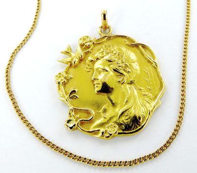l'image d'une pièce d'or sur laquelle figure le visage d'une femme
