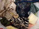 a pile of clothes that is sitting on a bed