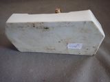 a small piece of white marble with a small sticker on it