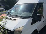 white van parked in a parking lot next to a house