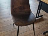a brown chair with a price tag on the back of it
