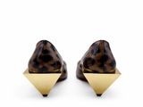 a pair of leopard print shoes with gold pyramids on the toes