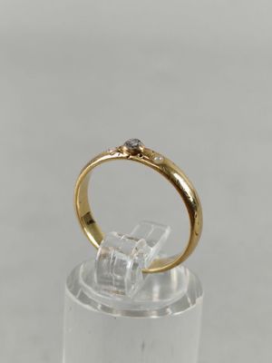 a close up of a gold ring with a diamond on it