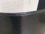 a close up of a black vase on a table