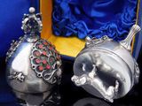 two silver bells sitting next to each other on a table