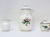 three different types of teapots and cups on a table