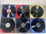 a set of four black vinyl records on a table