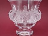 un vase en verre orné d'un motif sur un fond rouge