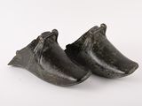 pair of black shoes on a white surface with a white background