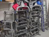 a lot of chairs that are stacked up in a room