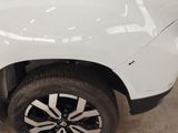 a close up of a white truck with a black rim