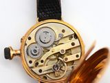 an image of a close up of a watch with a brown leather strap