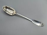 a silver spoon with a spoon handle on a table