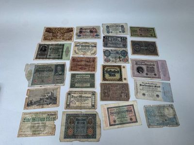 some old paper money sitting on top of a white table