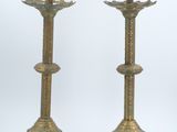 pair of antique brass candlesticks with ornate designs on each end