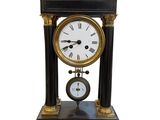 a black and gold clock sitting on top of a table