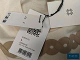 a white shirt with a tag on it and a tag attached to it