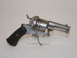 a gun that is sitting on top of a clear block
