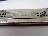 a silver harmonica that is sitting on a table