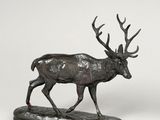 bronze sculpture of a stag on a wooden base on a white background