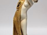 an image of a statue of a woman on a green base