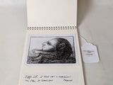 an open book with a drawing of a man ' s face on it