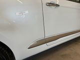 a white car parked in a garage with a sticker on the side of it